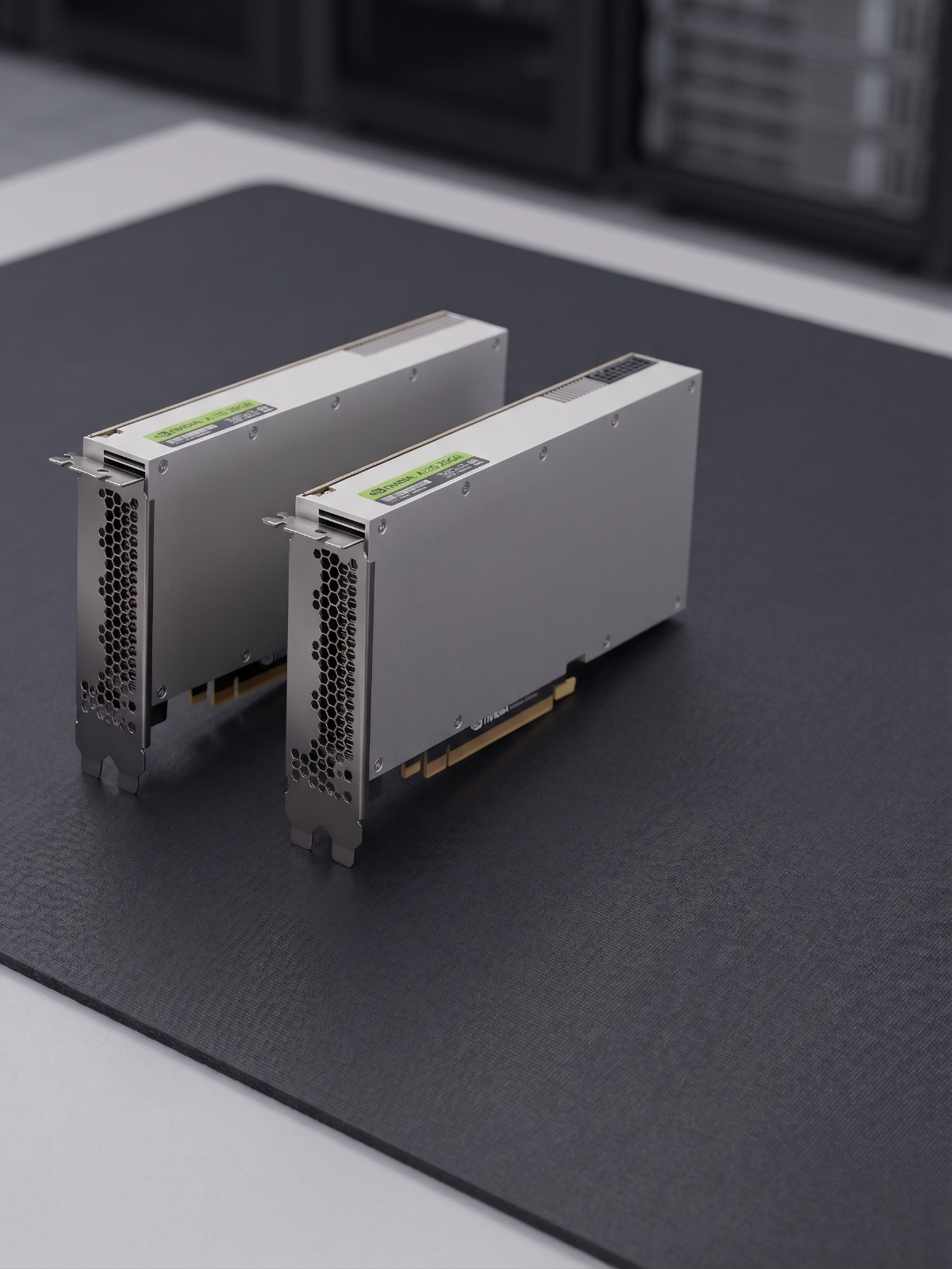 Two NVIDIA CMP 170HX graphics cards standing side by side on a workbench mat